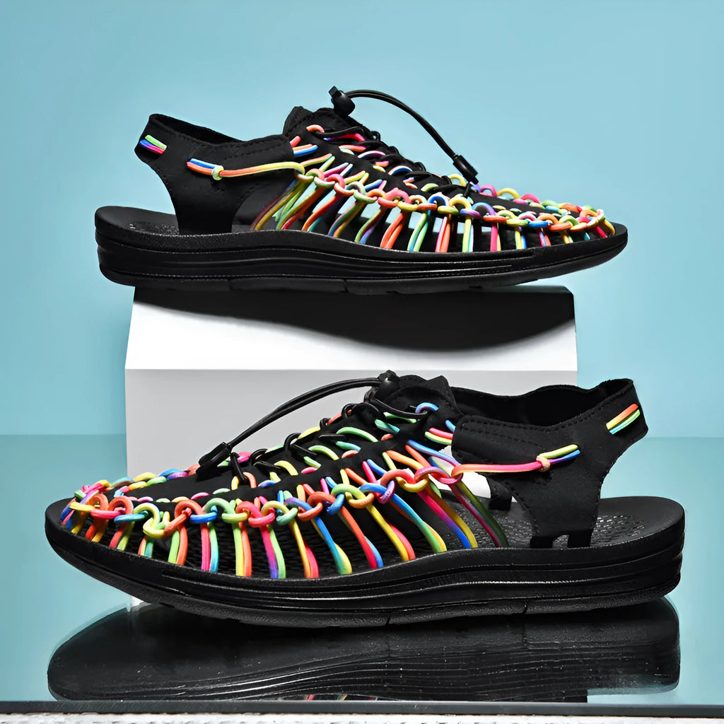Woven Roman-style sandals with elastic drawstrings in rainbow colour on a rubber sole.