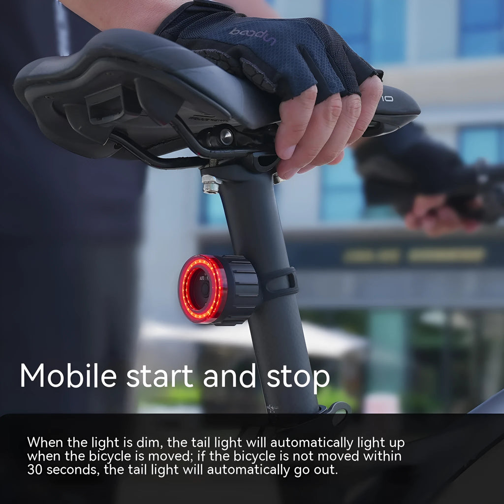 Black intelligent induction brake taillight for bicycles with aluminium alloy casing and mounting brackets.