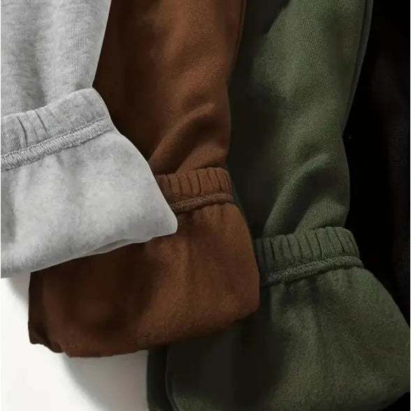 Four women's polyester sweatpants in black, green, brown and grey with straight leg and mid waist design