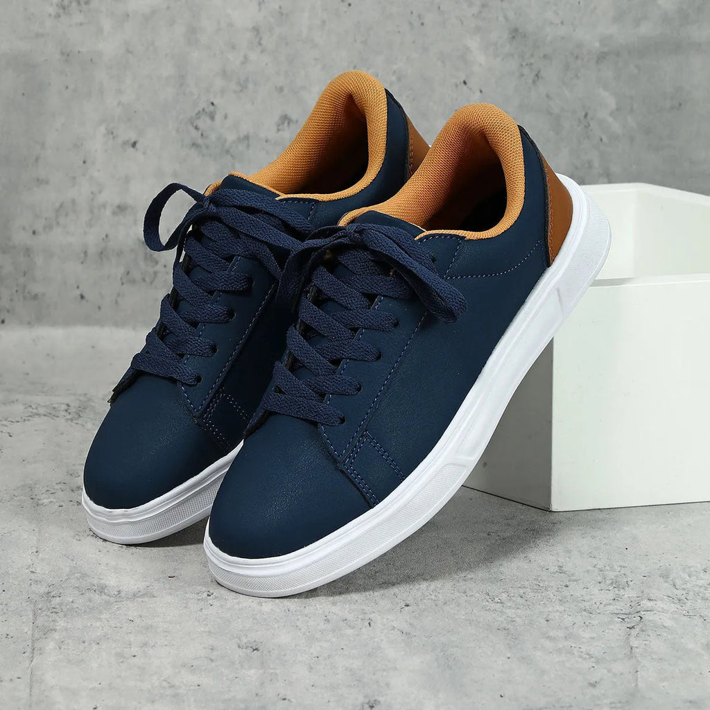 Platform skateboard casual sneaker in beige brown with low top, round toe, and a cross strap detail.