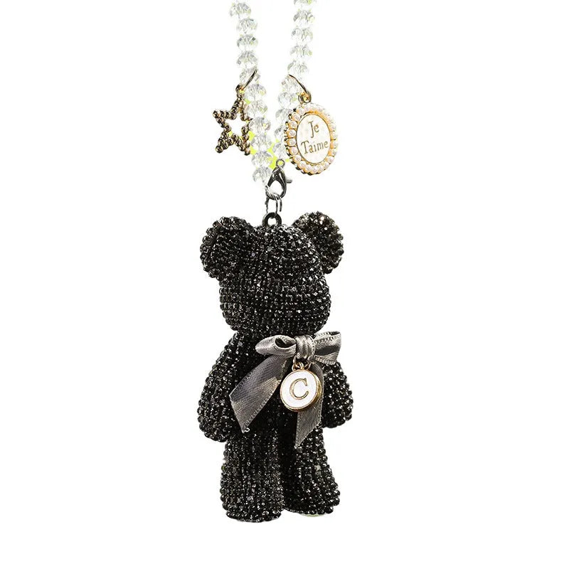 Black violent bear car mirror pendant with embedded crystal rhinestones on a white background.