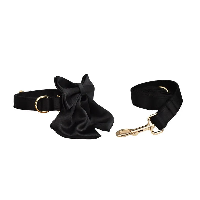 Dog wearing cloth collar and chest-strap vest harness with matching leash and decorative bow attached