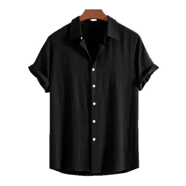Man wearing a loose black cotton-linen blend casual cardigan shirt on a beach.
