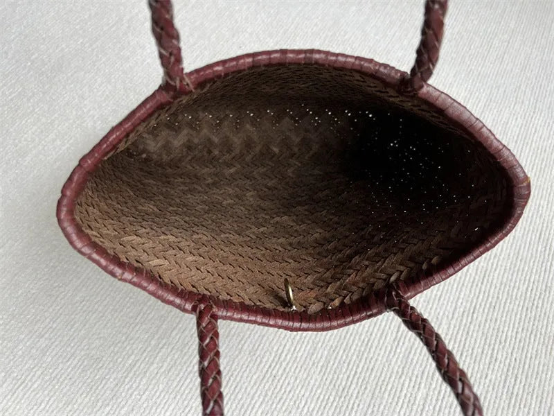 Brown handmade woven leather tote bag with a three-dimensional pocket.