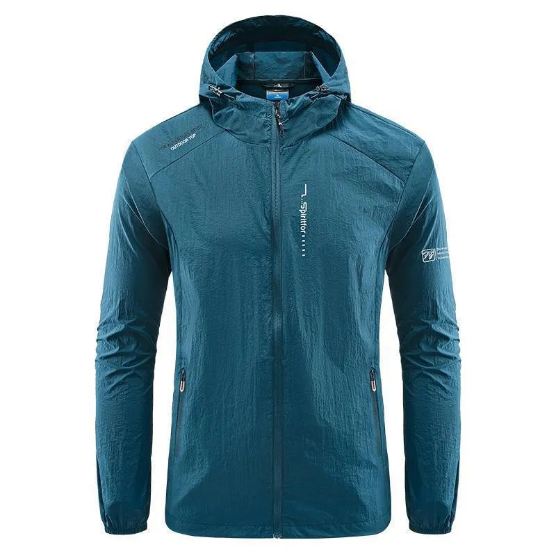 Man wearing a light grey loose-fit hooded nylon summer jacket outdoors.