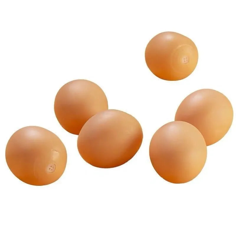 Red rubber egg-shaped dog chew toy with squeaker sound mechanism for dental care and interactive play.