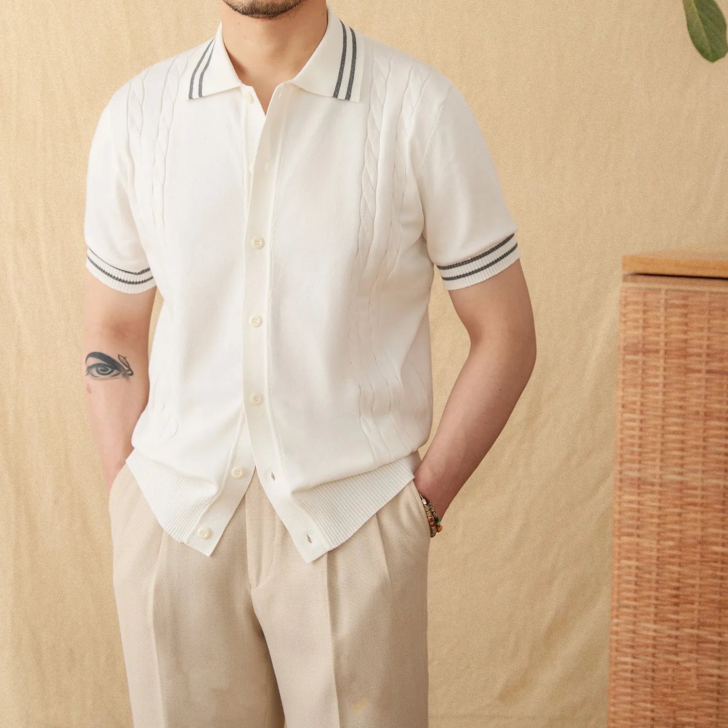 Man wearing a short-sleeved apricot lapel polo shirt made from cotton-polyester blend fabric.