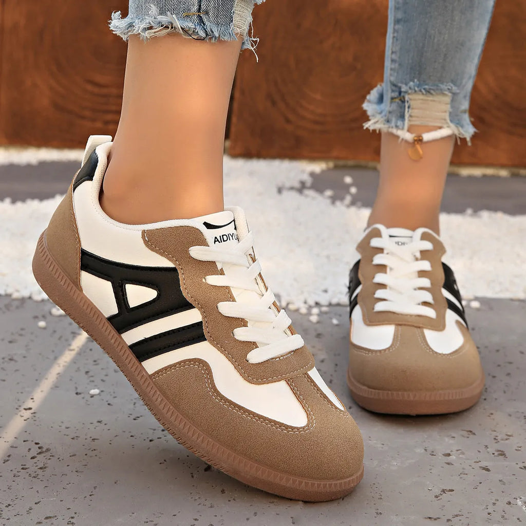 Retro lace-up women's jogging shoes in grey with a platform heel and cross strap detail.