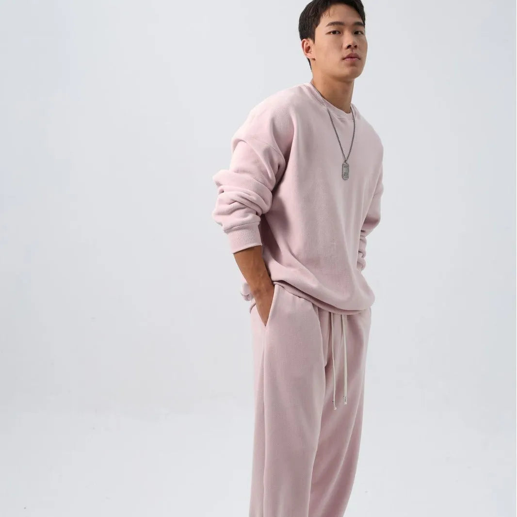 Man wearing a loose black polar fleece winter sports suit with crew neck coat and trousers