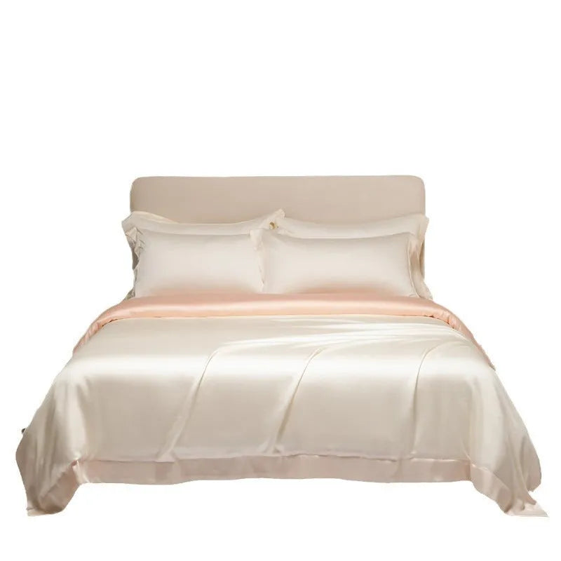 Luxury Lenzing Tencel bedding set in Aurora Blue on a bed, showing quilt cover, sheet, and two pillowcases.
