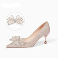 Women's champagne gold sequined pointed stiletto heel pumps for weddings, shown on a plain background.