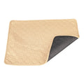 Tan and grey washable dog pee pad on a wooden floor, measuring 18 by 24 inches.