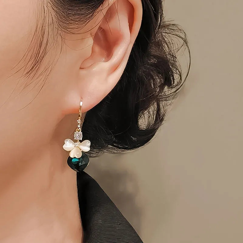 Women's blue crystal earrings with real gold plating bow shape and three-leaf flower motif