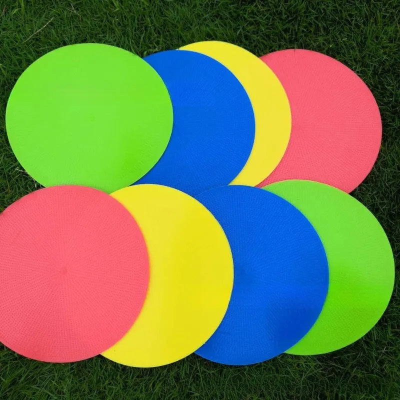 Yellow football training marker disc on grass field showing 23cm diameter flat design