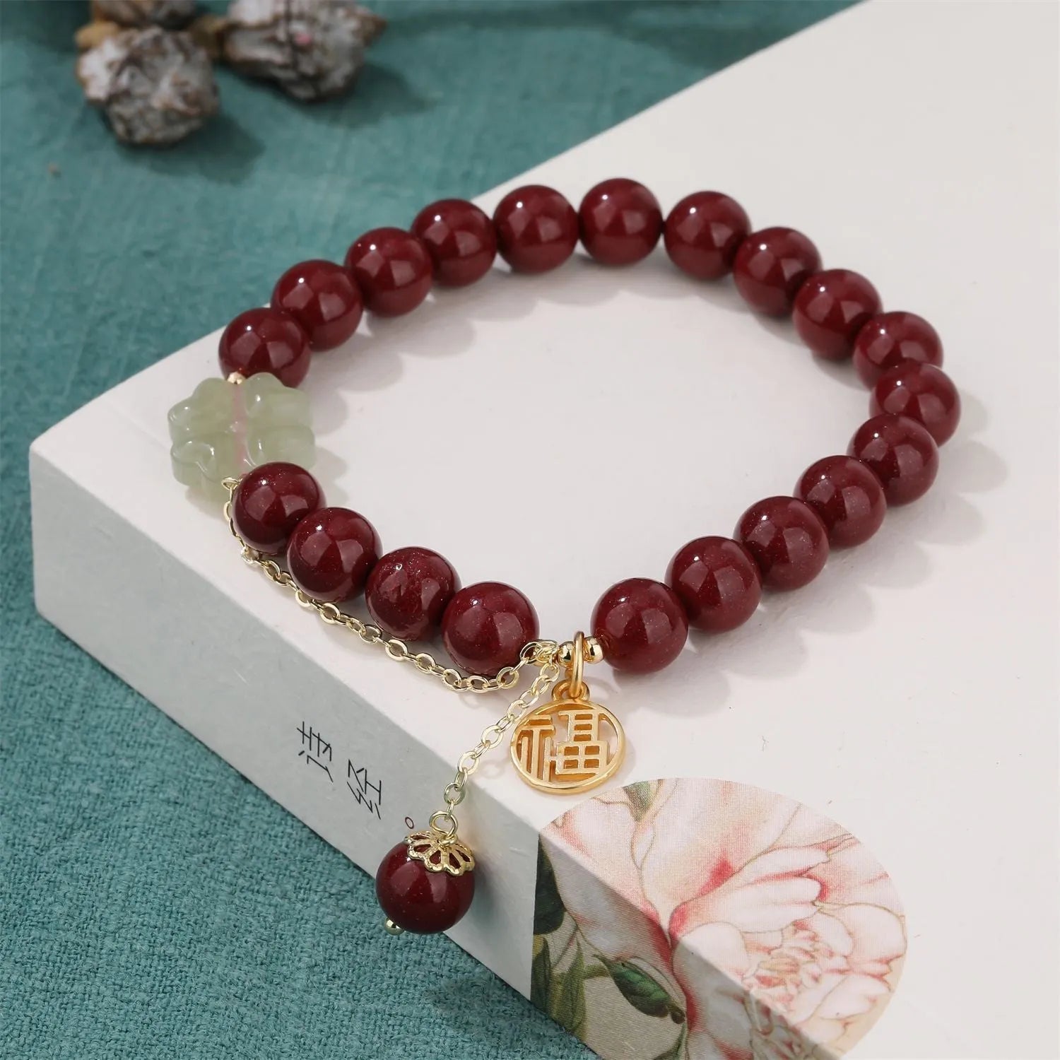 Women's cinnabar bracelet with Fu character charm and peach blossom tassels in purple gold sand colour
