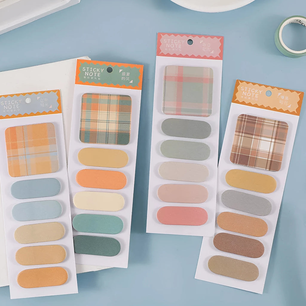 Colourful plaid sticky note memo pad showing eight different designs including blue, pink, and green patterns