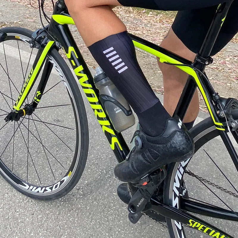 A pair of athletic cycling socks in a chemical fibre blend, shown in one of six available colours on a plain background.