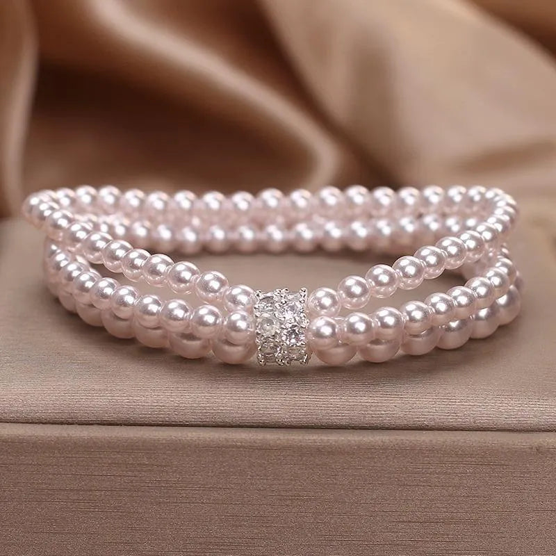 Baroque pearl multi-layer twin bracelet with pink and white imitation pearl beads on display