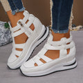 Women's black platform sandal with closed toe, hollow-out design, and Velcro ankle strap.