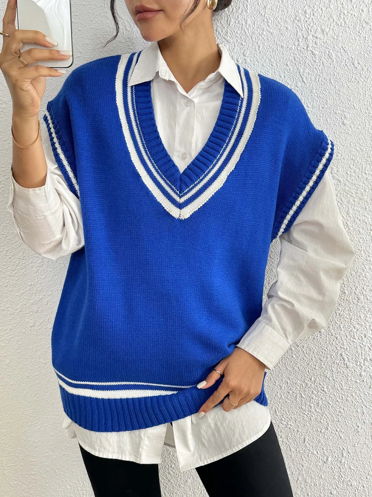 Women's loose blue college-style wool vest sweater, acrylic polyester blend, front view.