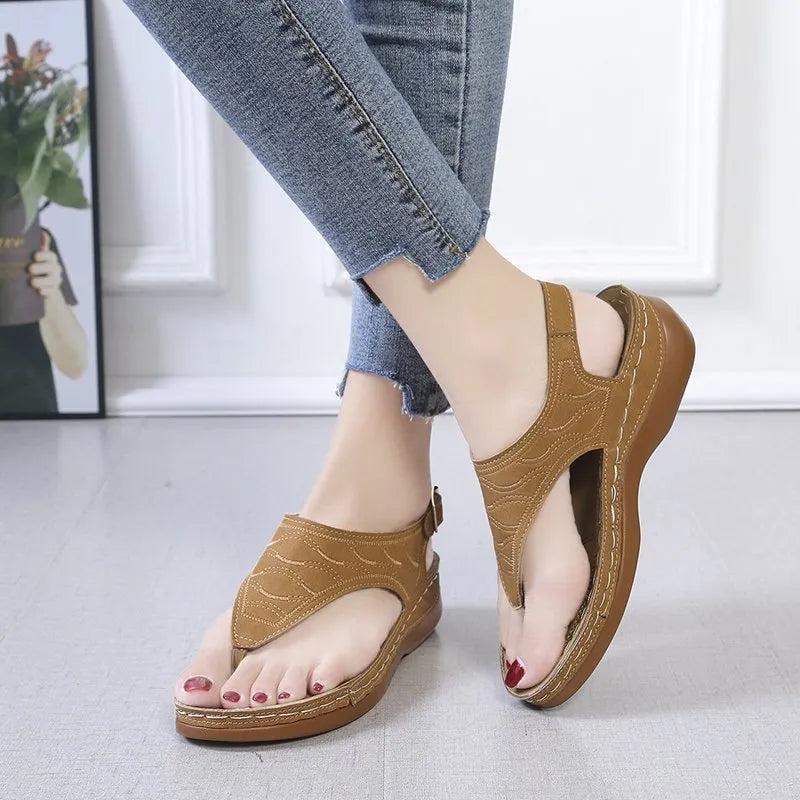 Women's black casual wedge heel flip flop sandals with an adjustable buckle strap.