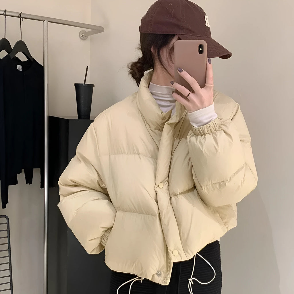 Women's loose thick polyester padded coat with zip front, available in seven solid colours and sizes S to L