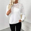 White women's long sleeve pullover top with a loose fit and floral pattern.