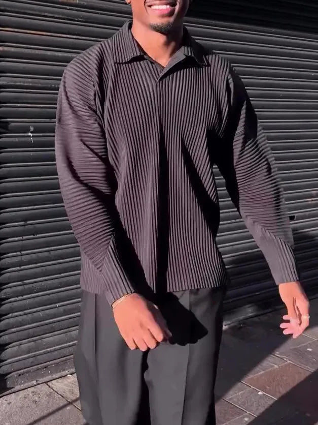 Man wearing a black pleated long-sleeved casual polyester top.
