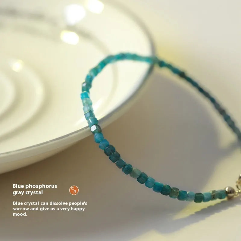 Women's blue apatite crystal bracelet with diamond-shaped beads on an elasticated band.