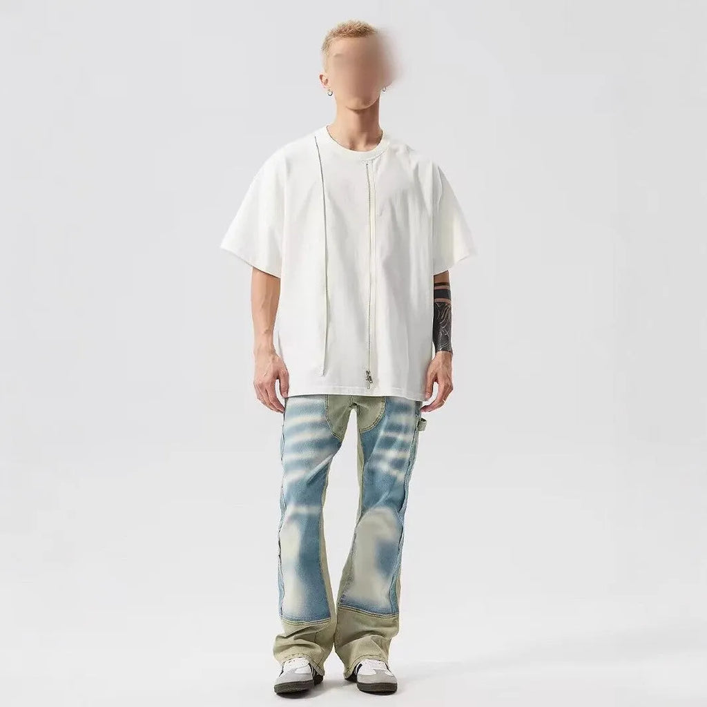 Yellow and blue retro patchwork jeans with splash-ink distressed design and zip fly.