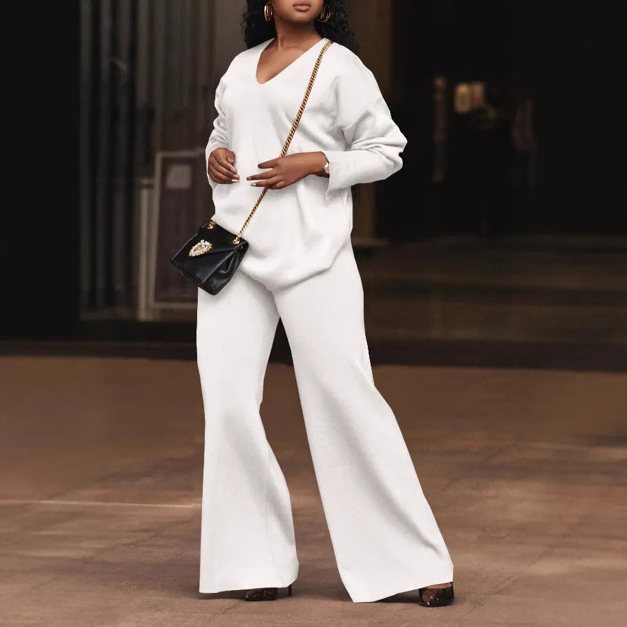 Women's brown thickened velvet two-piece suit with split sleeve top and trousers on a hanger.