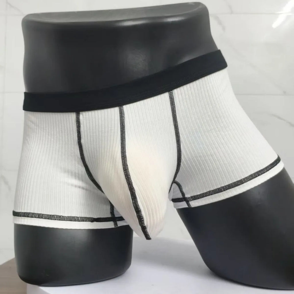 Men's solid colour breathable boxer shorts on a white background showing hip lifting design.