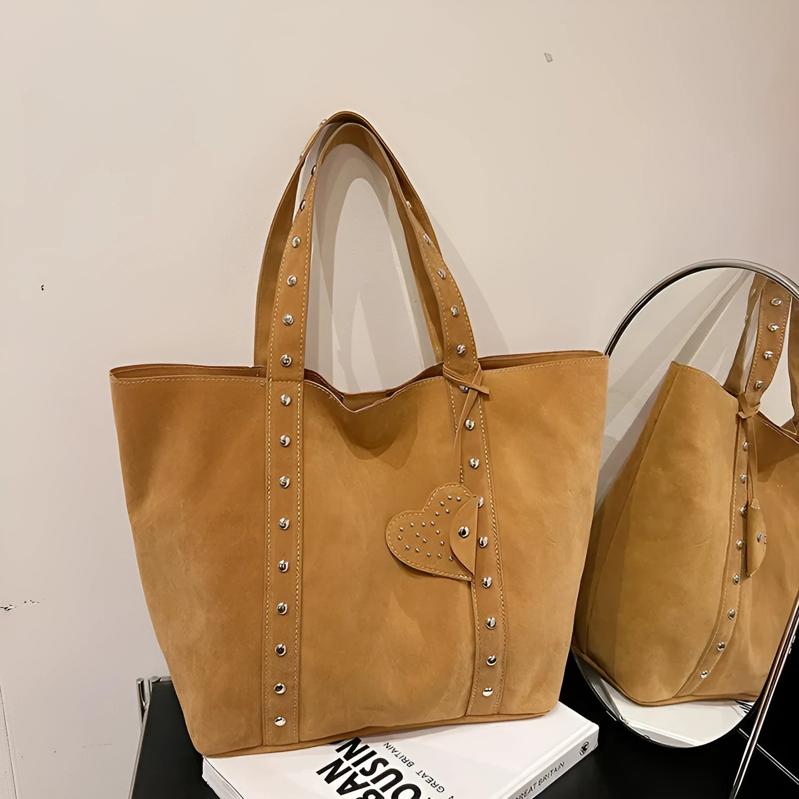 Black PU leather horizontal tote bag with double shoulder straps, showing outer sandwich pocket.