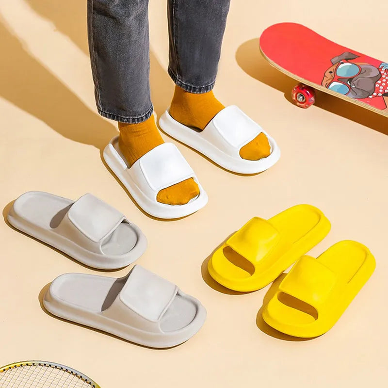 A pair of thick-soled EVA flip-flop slippers on a bathroom floor, showcasing non-slip tread and available colour options.