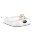 Pet cup warming holder in pink ABS and electroplated metal with a cup sitting on top