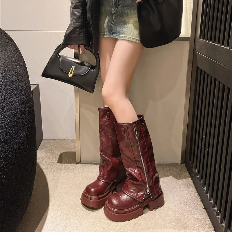 Black platform muffin pants Martin boots with a high cylinder, square heel, and rubber sole.