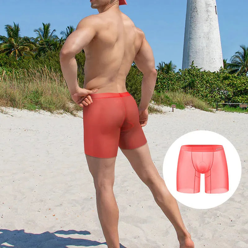 Men's low-waist boxers in solid orange, pink, or red made from breathable ice silk nylon fabric.