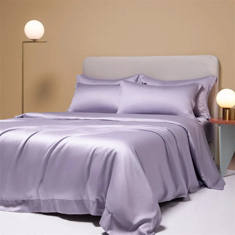 Luxury Lenzing Tencel bedding set in Aurora Blue on a bed, showing quilt cover, sheet, and two pillowcases.