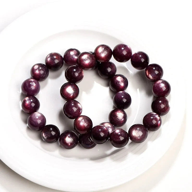 Purple lepidolite crystal round bead bracelet with polished finish and adjustable closure on a wrist.