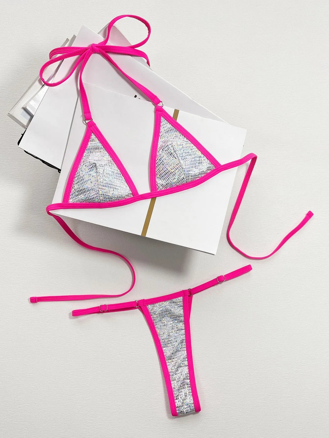 Silver one-piece women's swimsuit with a split triangle bag design on a mannequin.