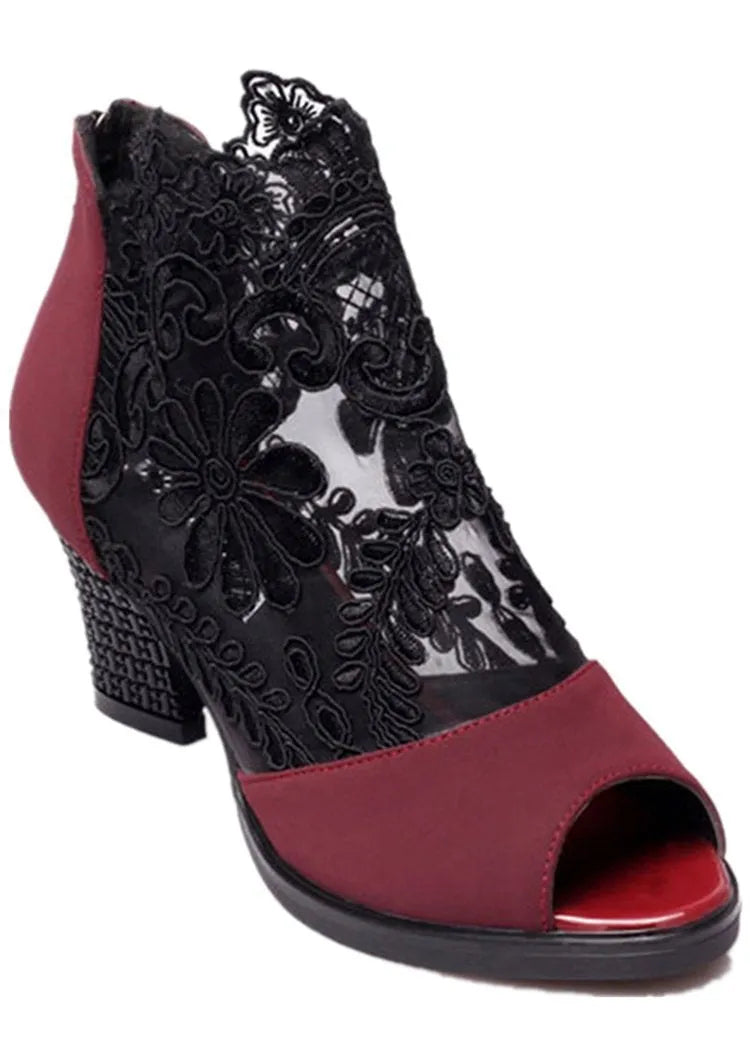 Black women's gladiator sandals with flower lace upper, square heel, and back zip closure.