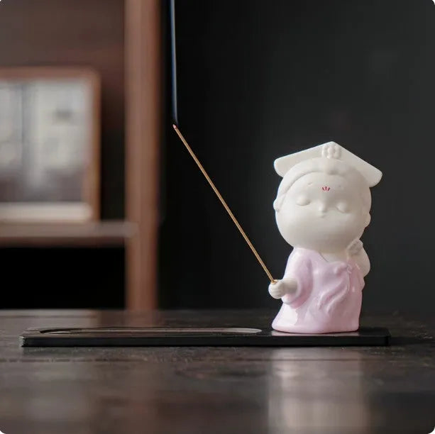 Ceramic cute court attendant incense burner decoration in fresh style on a plain background.