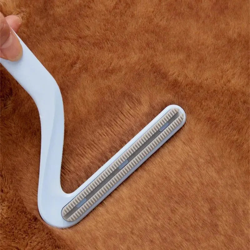 Double-sided pet hair removal comb in blue, white, and orange with sticky suction for cat and dog hair
