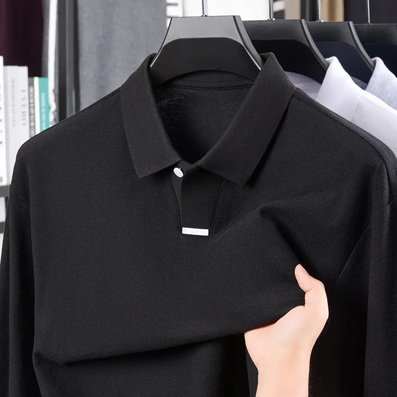 Man modelling a grey loose-fit cotton polo shirt with a lapel collar and asymmetric design.