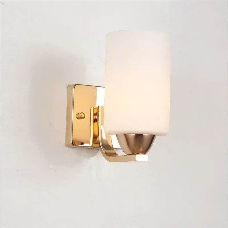 A modern chrome wall lamp with a clear glass shade, shown in single-head and double-head styles.