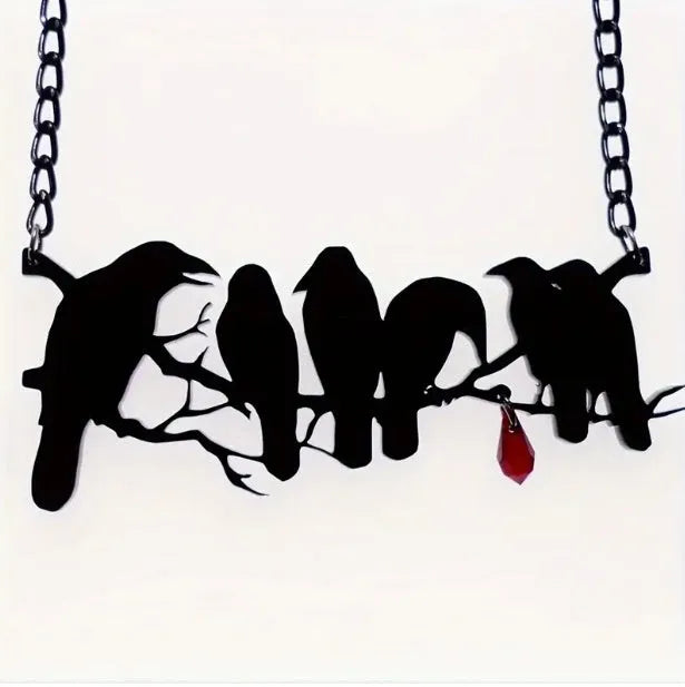 Black alloy crow pendant necklace on a cross chain for women, gothic bird motif jewellery.