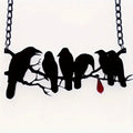 Black alloy crow pendant necklace on a cross chain for women, gothic bird motif jewellery.