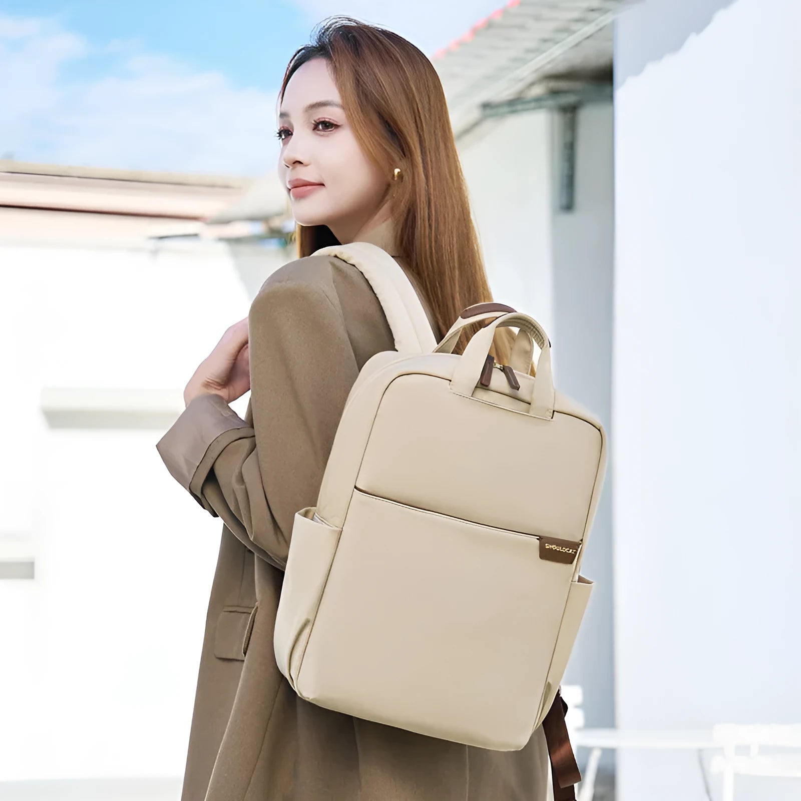 Women's nylon travel backpack showing laptop compartment and multiple internal organisers in apricot colour