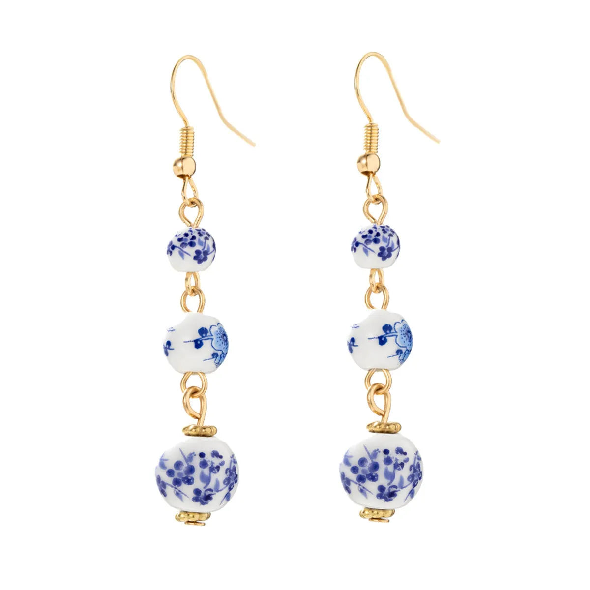 Long blue and white porcelain ceramic bead earrings with geometric alloy details on a white background.