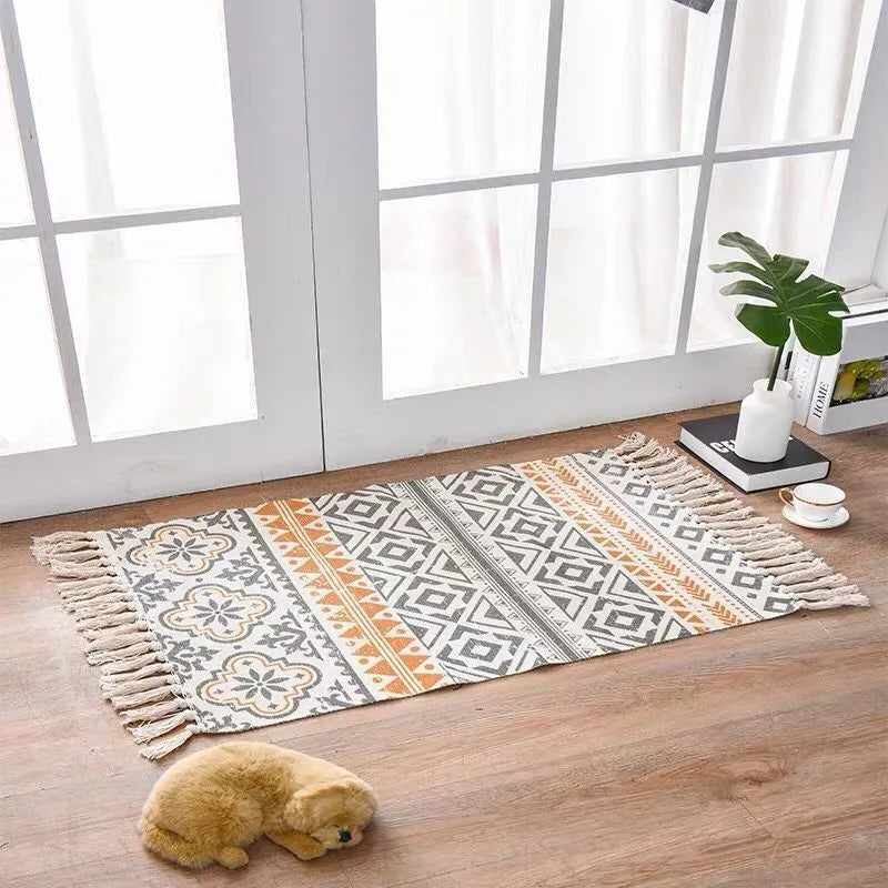 Handwoven cotton linen floor mat 60x90cm in ethnic style with natural plant dye, placed on a wooden floor